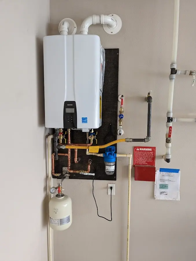 Professional plumber installing copper piping in a East Palestine home